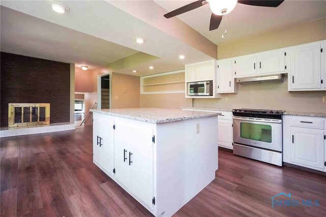 1440 N State Route 19, Republic, OH 44867 - kitchen featuring a center island, white cabinetry, under cabinet range hood, a ceiling fan, and appliances with stainless steel finishes