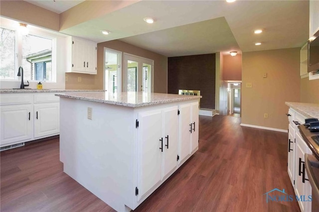 1440 N State Route 19, Republic, OH 44867 - kitchen featuring light stone counters, dark wood-style flooring, a kitchen island, and white cabinets