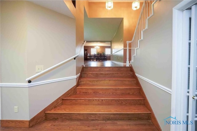 1440 N State Route 19, Republic, OH 44867 - stairway featuring baseboards, a chandelier, and wood finished floors