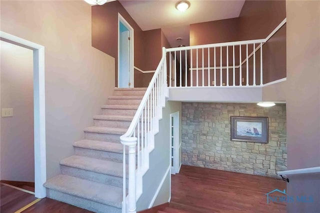 stairs featuring wood finished floors