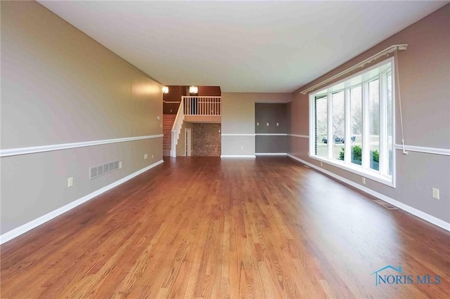 1440 N State Route 19, Republic, OH 44867 - unfurnished living room with baseboards, visible vents, and wood finished floors