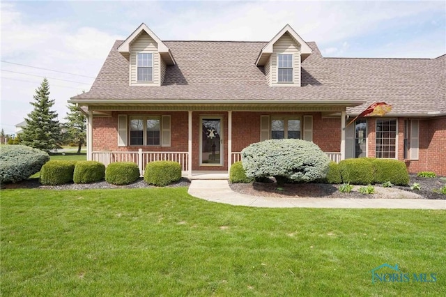2028 Lakeland Dr, Findlay, OH 45840 - view of front of home with brick siding, a front lawn, roof with shingles, and a porch