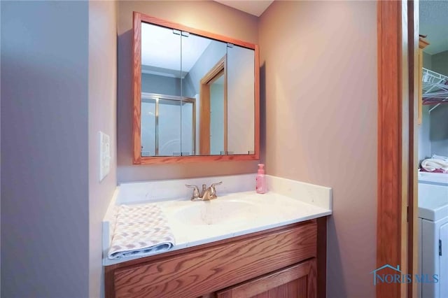2028 Lakeland Dr, Findlay, OH 45840 - bathroom with washer / clothes dryer, a shower stall, and vanity