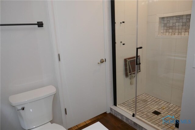 6553 Abbey Run Unit D13, Sylvania, OH 43560 - bathroom with a stall shower, toilet, and wood finished floors