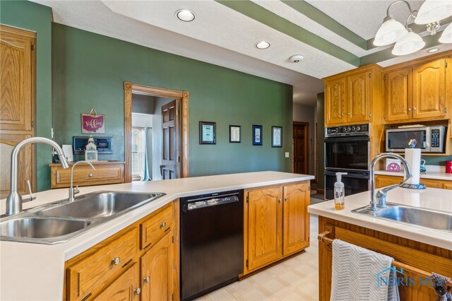 kitchen featuring a sink, light countertops, black appliances, and light floors