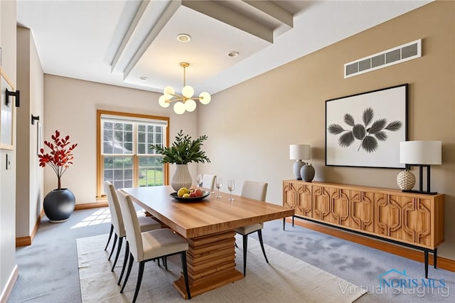 carpeted dining area with baseboards, a chandelier, and visible vents