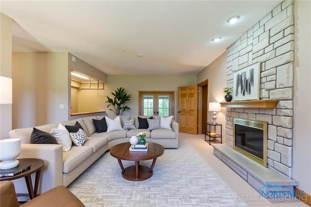 living room featuring carpet floors, french doors, recessed lighting, and a stone fireplace