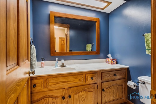 bathroom featuring vanity and toilet