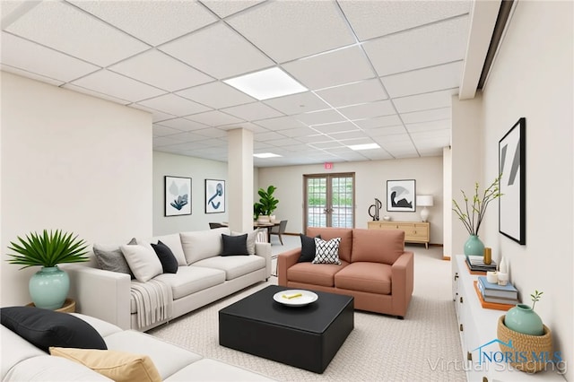 carpeted living room featuring a drop ceiling
