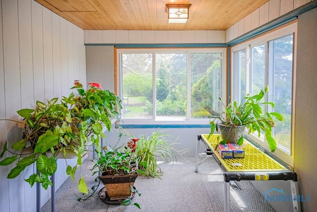 sunroom / solarium featuring wooden ceiling and plenty of natural light