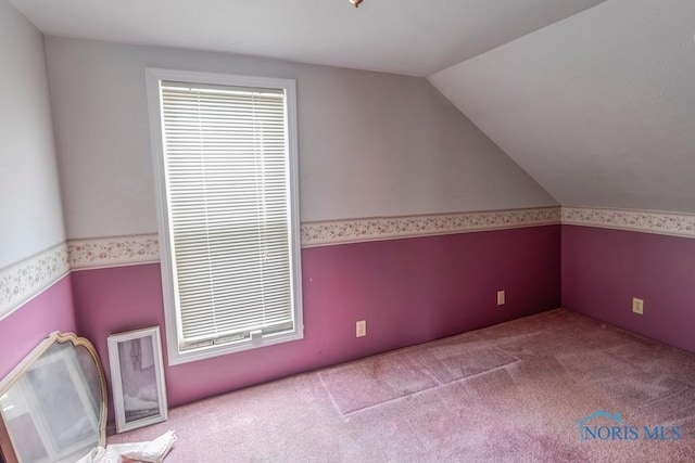 bonus room with carpet, vaulted ceiling, and wallpapered walls