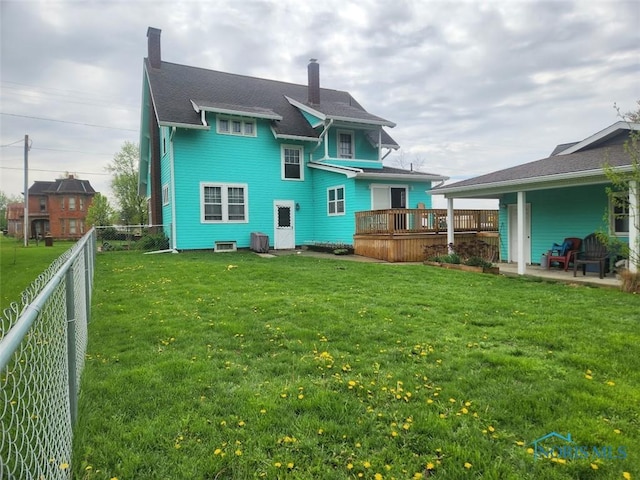 602 W Main St, Fayette, OH 43521 - rear view of house with a chimney, a deck, and a patio