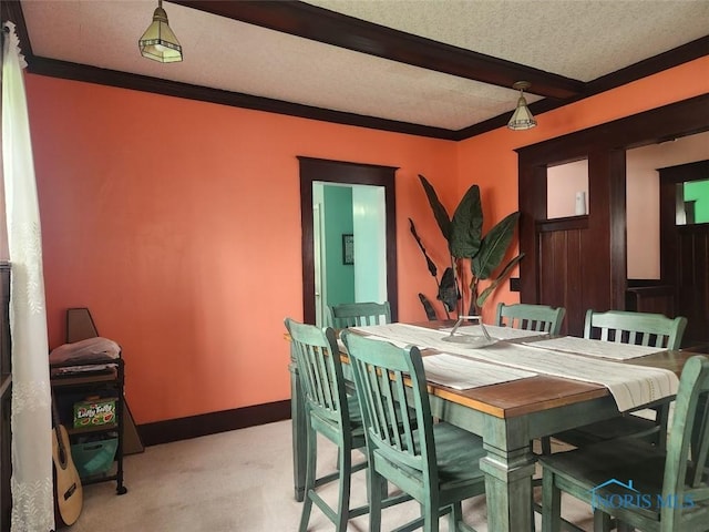 602 W Main St, Fayette, OH 43521 - dining room featuring light carpet, beam ceiling, and a textured ceiling