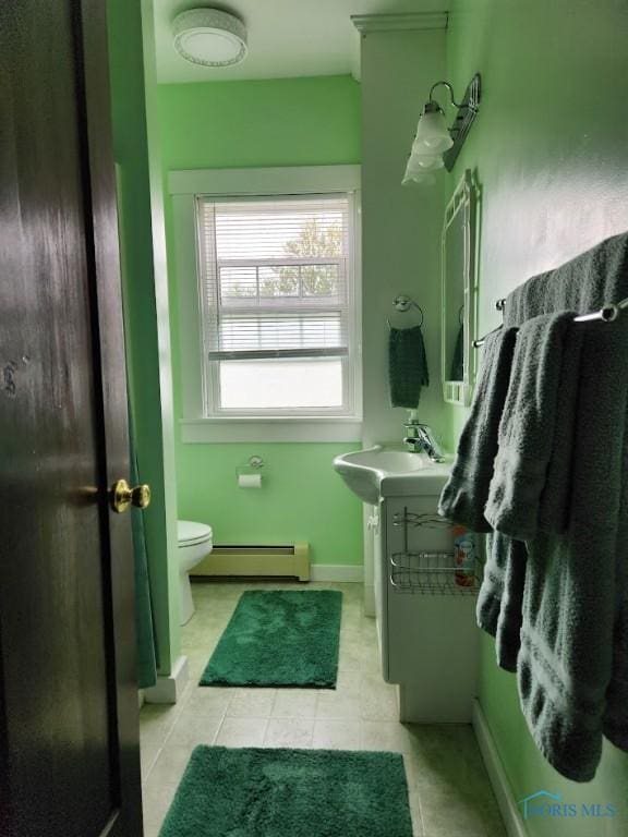 602 W Main St, Fayette, OH 43521 - bathroom with baseboard heating, vanity, toilet, tile patterned floors, and baseboards