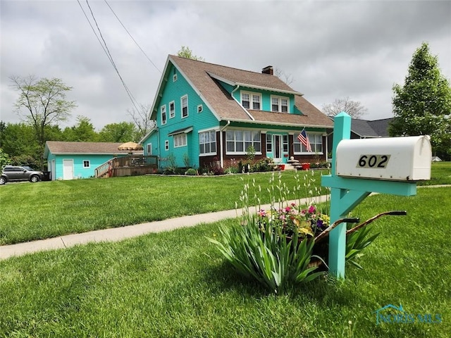 602 W Main St, Fayette, OH 43521 - view of front of house with a chimney and a front lawn