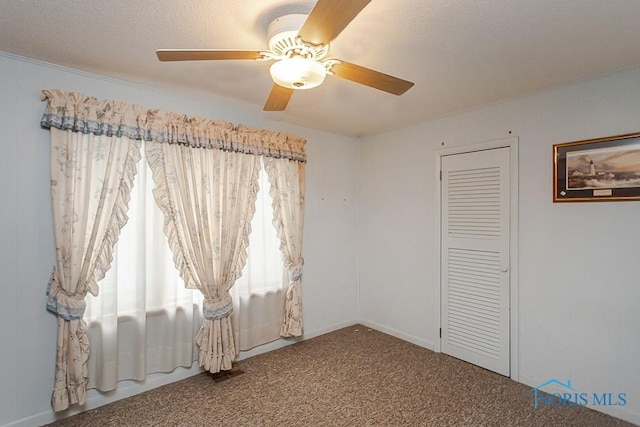 unfurnished bedroom featuring a closet, a ceiling fan, and carpet