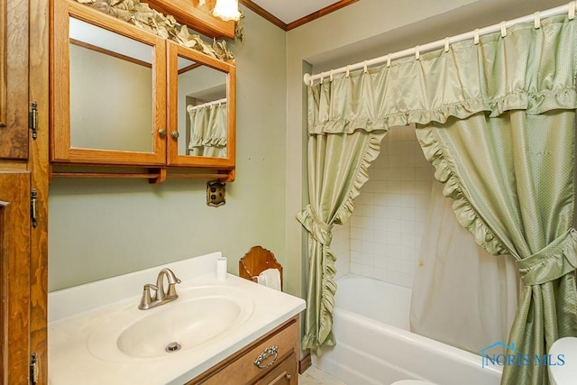 bathroom with vanity, ornamental molding, and shower / tub combo