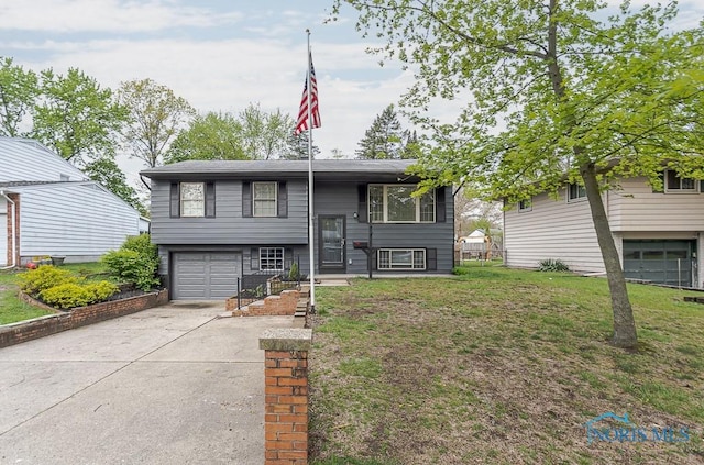 2509 Orchard Hills Blvd, Toledo, OH 43615 - raised ranch featuring an attached garage, concrete driveway, and a front yard