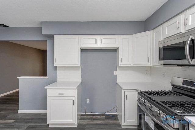 2509 Orchard Hills Blvd, Toledo, OH 43615 - kitchen with appliances with stainless steel finishes, white cabinetry, light countertops, tasteful backsplash, and dark wood finished floors