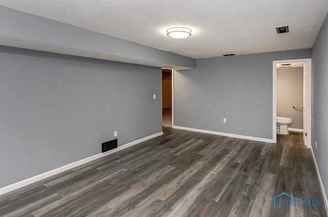 2509 Orchard Hills Blvd, Toledo, OH 43615 - finished basement featuring dark wood-style flooring, baseboards, and a textured ceiling