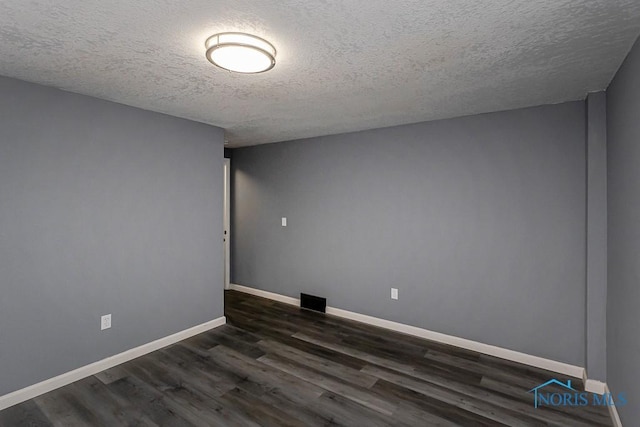 2509 Orchard Hills Blvd, Toledo, OH 43615 - spare room featuring a textured ceiling, dark wood-type flooring, and baseboards