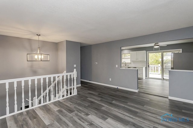 2509 Orchard Hills Blvd, Toledo, OH 43615 - empty room with baseboards, a chandelier, dark wood-type flooring, and a ceiling fan