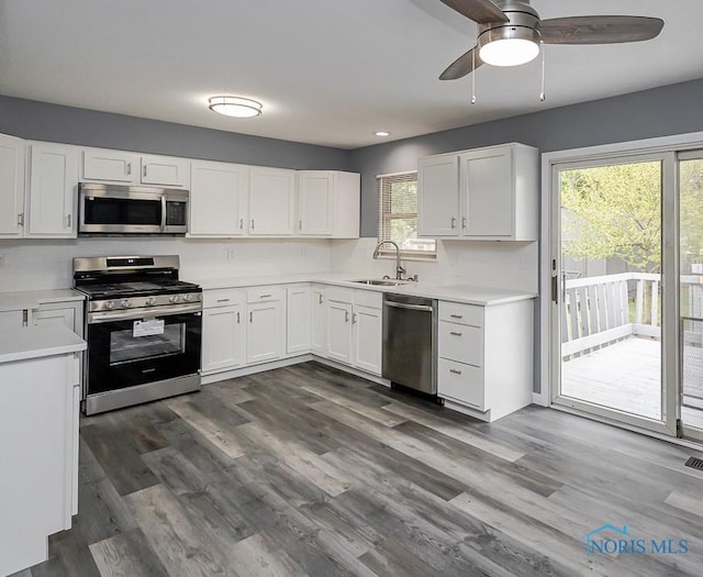 2509 Orchard Hills Blvd, Toledo, OH 43615 - kitchen with stainless steel appliances, a sink, ceiling fan, white cabinetry, and light countertops