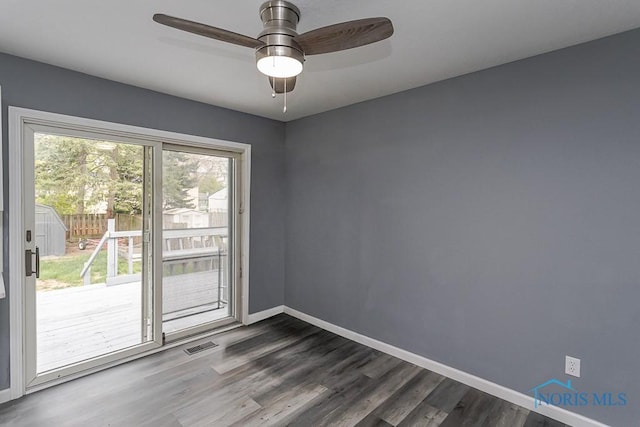 2509 Orchard Hills Blvd, Toledo, OH 43615 - spare room featuring baseboards, dark wood finished floors, and a ceiling fan