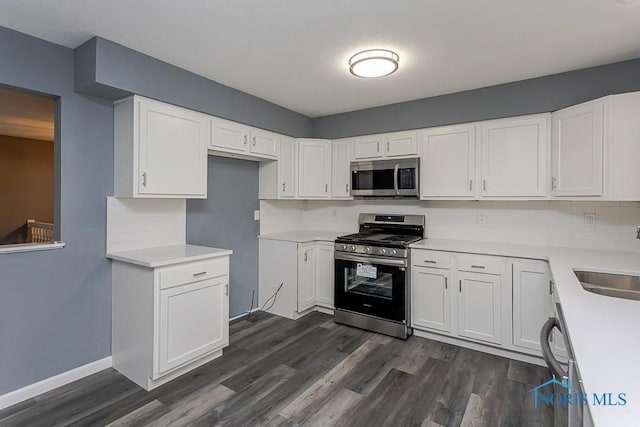 2509 Orchard Hills Blvd, Toledo, OH 43615 - kitchen featuring stainless steel appliances, dark wood-type flooring, and white cabinets