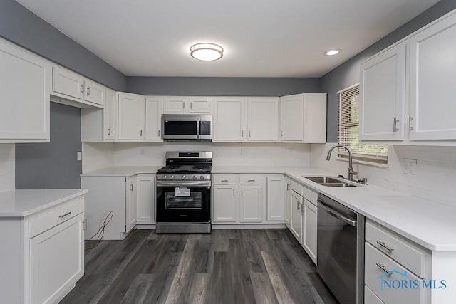 2509 Orchard Hills Blvd, Toledo, OH 43615 - kitchen with appliances with stainless steel finishes, a sink, white cabinets, dark wood finished floors, and recessed lighting
