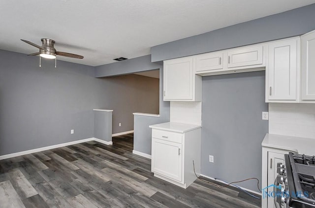 2509 Orchard Hills Blvd, Toledo, OH 43615 - kitchen with ceiling fan, stainless steel gas range oven, white cabinets, and dark wood-type flooring