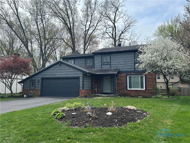 traditional-style house with an attached garage, driveway, a front lawn, and brick siding