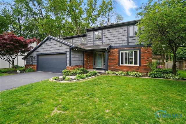 2369 Saint James Woods Blvd, Toledo, OH 43617 - view of front facade with driveway, a garage, and brick siding