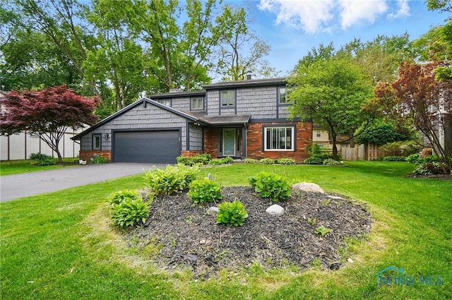 2369 Saint James Woods Blvd, Toledo, OH 43617 - view of front of house featuring driveway, a garage, and brick siding