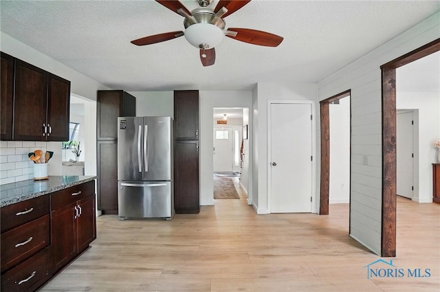 2369 Saint James Woods Blvd, Toledo, OH 43617 - kitchen with freestanding refrigerator, healthy amount of natural light, a ceiling fan, dark brown cabinets, and a textured ceiling