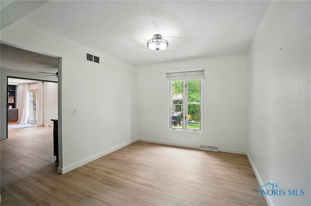 2369 Saint James Woods Blvd, Toledo, OH 43617 - spare room featuring wood finished floors, a textured ceiling, baseboards, and ceiling fan