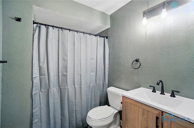 2369 Saint James Woods Blvd, Toledo, OH 43617 - full bathroom featuring a textured wall, toilet, vanity, and a shower with shower curtain