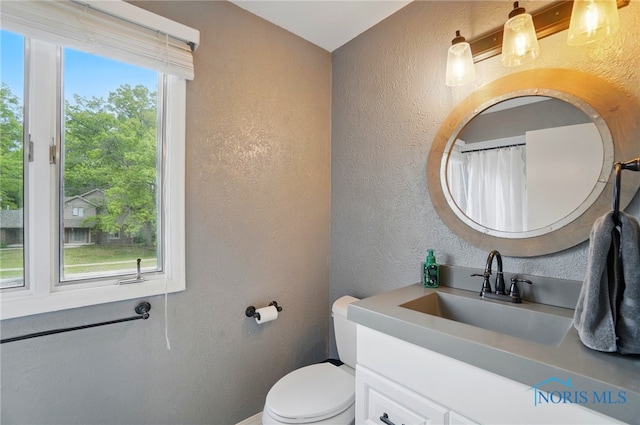 2369 Saint James Woods Blvd, Toledo, OH 43617 - bathroom with a textured wall, toilet, and vanity