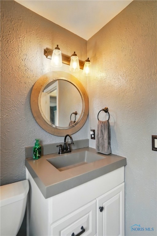 2369 Saint James Woods Blvd, Toledo, OH 43617 - half bath featuring a textured wall, vanity, and toilet