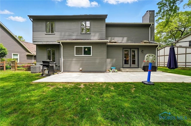 2369 Saint James Woods Blvd, Toledo, OH 43617 - rear view of property featuring a patio area, entry steps, a chimney, and cooling unit