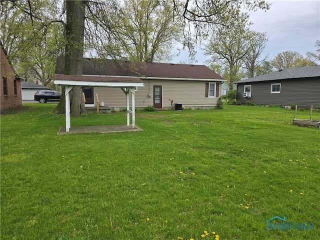 107 Superior St, Oakwood, OH 45873 - back of property with a lawn and a patio area