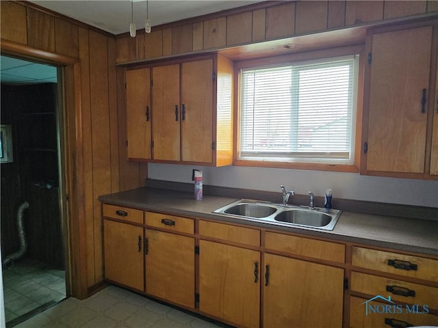 107 Superior St, Oakwood, OH 45873 - kitchen featuring brown cabinetry, a sink, and wooden walls