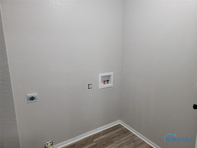 washroom featuring washer hookup, laundry area, baseboards, electric dryer hookup, and wood finished floors