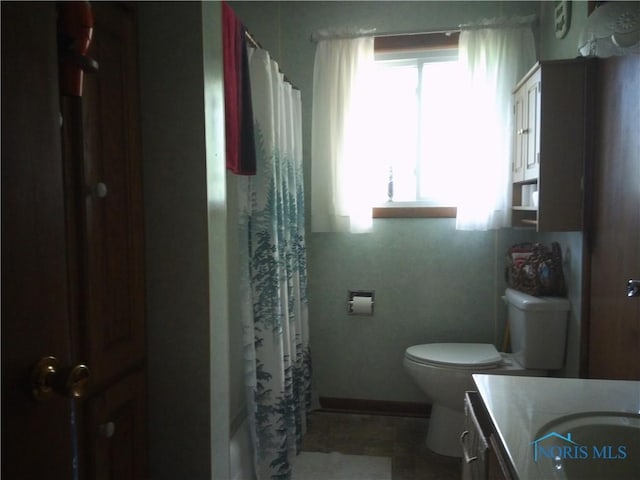 1805 Ayersville Ave, Defiance, OH 43512 - bathroom featuring vanity, toilet, a shower with shower curtain, and baseboards