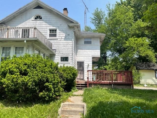 2004 Calumet Ave, Toledo, OH 43607 - back of property with a chimney, a deck, and a balcony