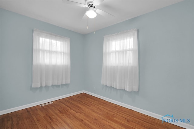1137 Rosedale St, Maumee, OH 43537 - spare room featuring healthy amount of natural light, baseboards, a ceiling fan, and wood finished floors