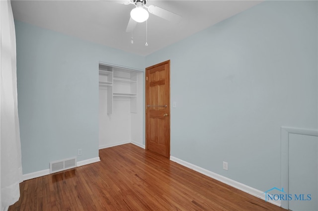 1137 Rosedale St, Maumee, OH 43537 - unfurnished bedroom with baseboards, wood finished floors, a closet, and a ceiling fan