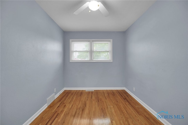 1137 Rosedale St, Maumee, OH 43537 - unfurnished room with baseboards, a ceiling fan, and wood finished floors