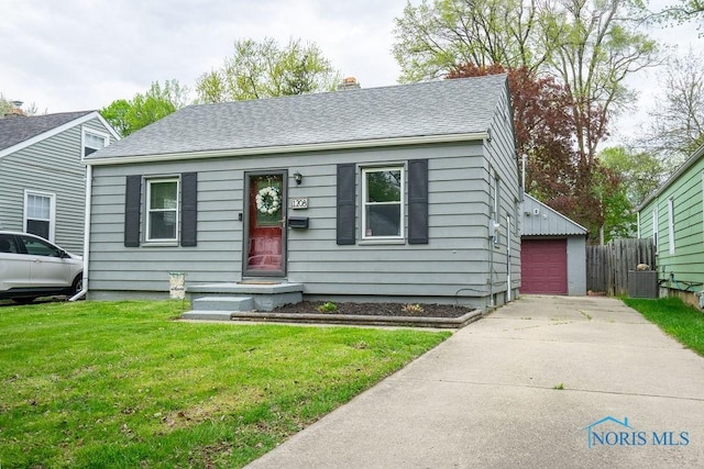 bungalow with fence, roof with shingles, a garage, a front yard, and a chimney