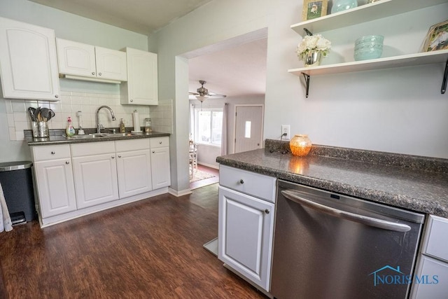 kitchen featuring a sink, dark wood-style flooring, dishwasher, and dark countertops